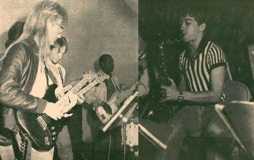 Black and white photo of musicians playing; on the left, three people play electric guitars and a bass, while on the right, a man wearing a striped shirt plays a saxophone and sings into a microphone.